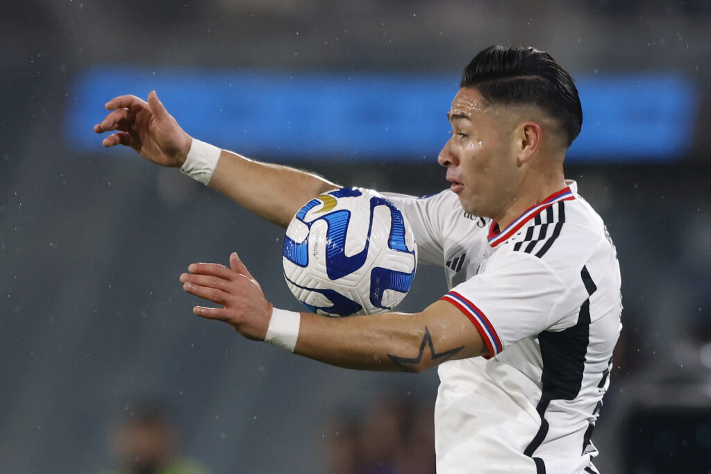 Óscar Opazo amortiguando un balón con el pecho mientras defiende la camiseta de Colo-Colo.