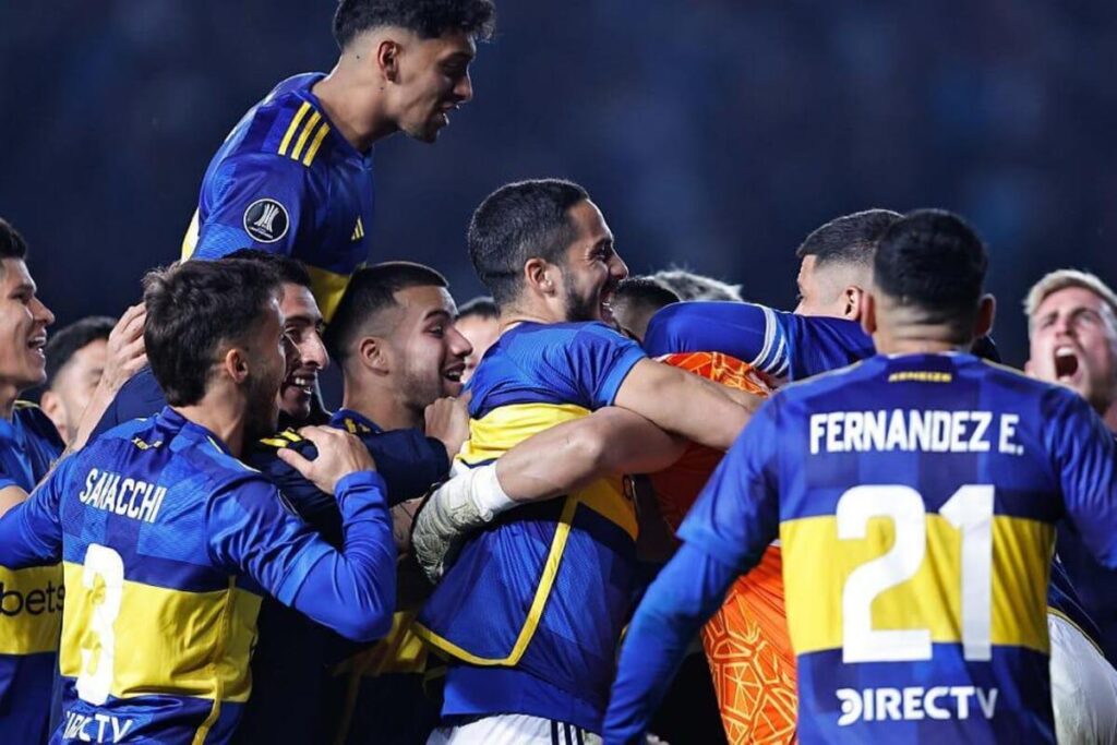 Jugadores de Boca Juniors abrazados celebrando un gol.