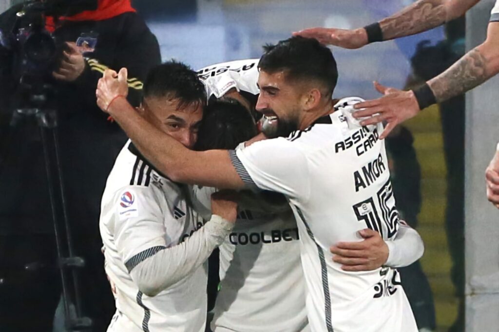 Plantel de Colo-Colo abrazado celebrando un gol.