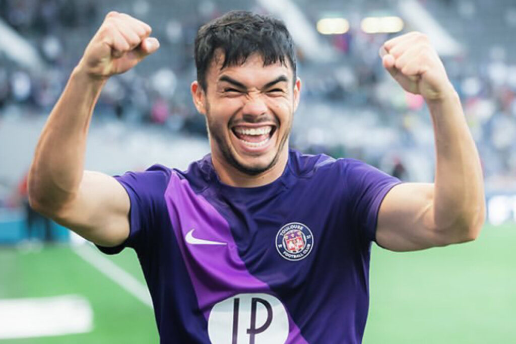 Gabriel Suazo sonriendo con los brazos en el aire.